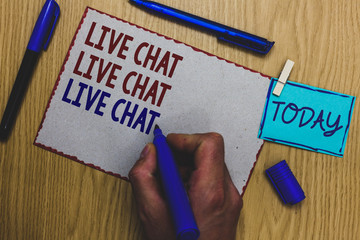 Conceptual hand writing showing Live Chat Live Chat Live Chat. Business photo text talking with people friends relatives online Man holding marker paper clothespin express ideas wooden table