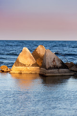 Seascape. Concrete pyramids in the light before sunset. Shabla, Northern Black Sea Coast, Bulgaria.