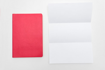 Office worker's Desk, red notebook, letter or white piece of paper, background, copy space, for recording, text, close up, top view