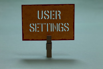 Text sign showing User Settings. Conceptual photo Configuration of appearance Operating System Personalized Clothespin holding orange paper important communicating message ideas
