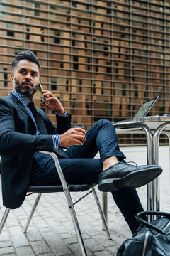 Young Indian Businessman on using a Mobile Phone in the City