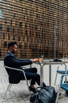 Adult Wlwgant Businessman Working Outdoor on His Laptop