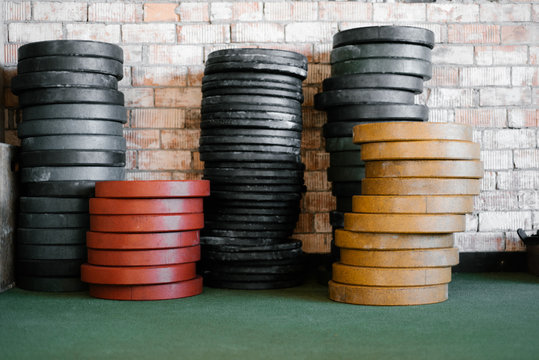 Stack of metal weight plates in gym