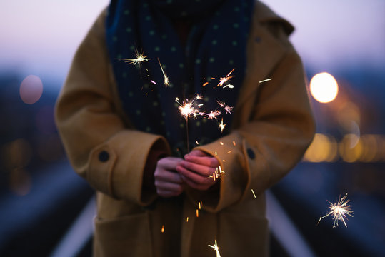 Young asian girl playing with sparklers on New Year's Eve