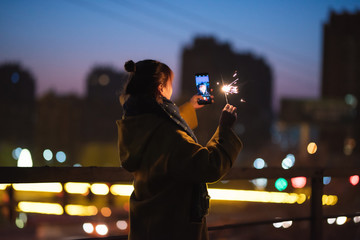 Young asian girl playing with sparklers on New Year's Eve