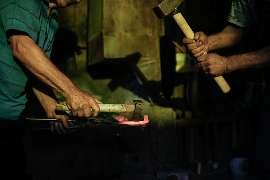 Blacksmiths working in a workshop