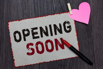 Text sign showing Opening Soon. Conceptual photo Going to be available or accessible in public anytime shortly White page red borders marker clothespin holds paper heart wood background