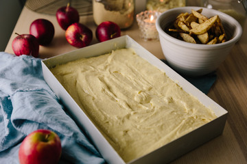 Cake batter in pan with apples ready to be added to top