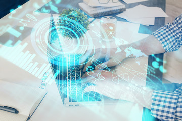 Double exposure of businessman working on laptop on background. International business hologram in front. Concept of success.