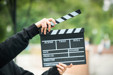 clapperboard in hands on outdoor