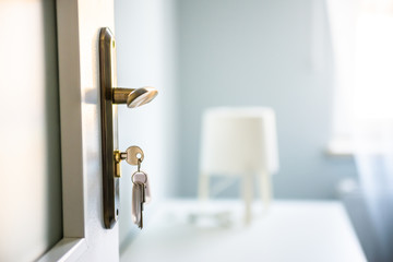 Bright Hi photo of keys in the door's lock. Relocation, housing estate concept. New construction...