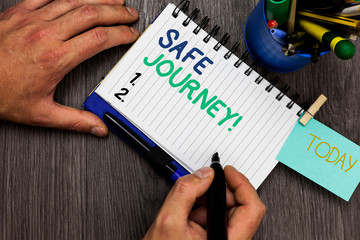Conceptual hand writing showing Safe Journey. Business photo showcasing Blessing Bid farewell Drive carefully Use seatbelt Strap Man holding marker notebook reminder cup markers wood table