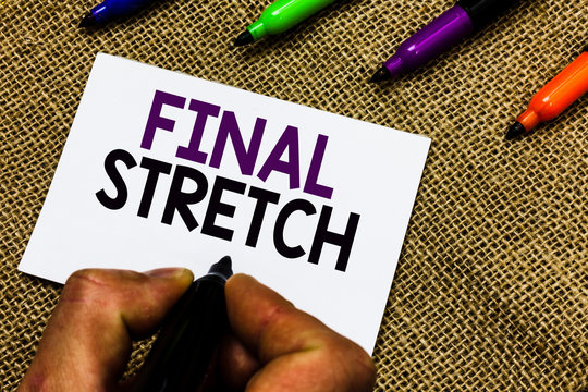 Writing note showing Final Stretch. Business photo showcasing Last Leg Concluding Round Ultimate Stage Finale Year ender Man hand holding marker white paper communicating idea Jute background