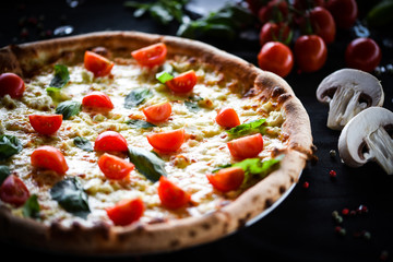 fresh italian pizza with mozzarella, cherry tomatoes & basil