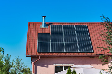 Solar panels on the roof of a country house, environmental production of solar energy in electrical.