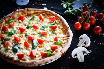 fresh italian pizza with mozzarella, cherry tomatoes & basil