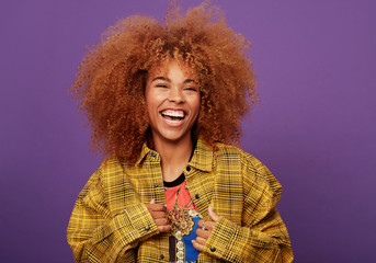 beautiful woman laughing over purple background