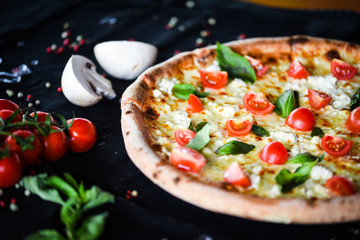 fresh italian pizza with mozzarella, cherry tomatoes & basil