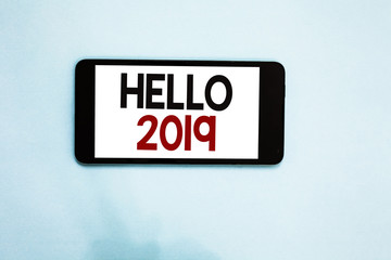 Text sign showing Hello 2019. Conceptual photo Hoping for a greatness to happen for the coming new year Cell phone white screen over light blue background text messages apps