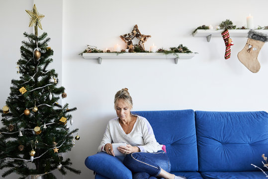 Reading e-book on christmas at home.