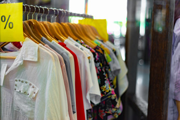 Fashionable and elegant clothes hanging on a hanger in a store for lovers of a choice of...