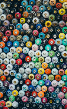 Composed rows of spray paint bottles