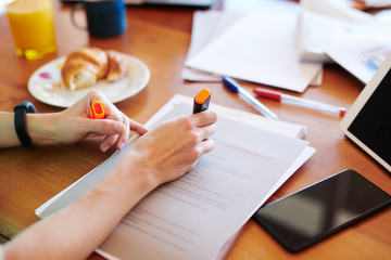 Crop woman highlighting information in text