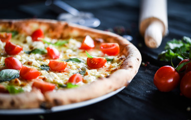 fresh italian pizza with mozzarella, cherry tomatoes & basil