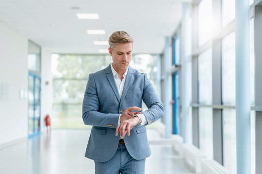 Businessman in a passageway checking the time