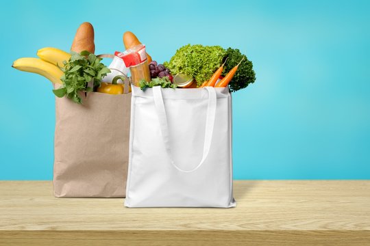 Shopping bags with groceries isolated on white background