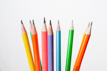 colored pencils in the shape of a star on a white background