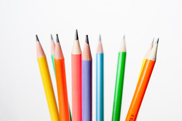 colored pencils in the shape of a star on a white background
