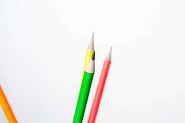colored pencils in the shape of a star on a white background