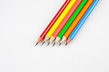 colored pencils in the shape of a star on a white background