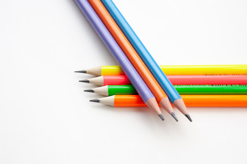 colored pencils in the shape of a star on a white background