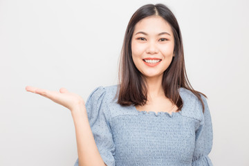 Beautiful smiling asian women show welcome hand gesture