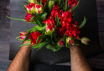 Man holding bouquet of beautiful spring tulips closeup. International Women's Day