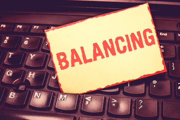 Writing note showing Balancing. Business photo showcasing put something in a steady position so...