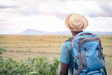 African tourist  traveler man with backpack on view of mountain background