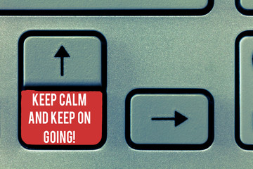 Fototapeta premium Conceptual hand writing showing Keep Calm And Keep On Going. Business photo text Get relaxed and continue moving taking action Keyboard Intention to create computer message keypad idea