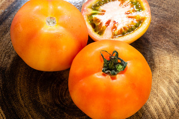 tomatoes on rustic wooden background