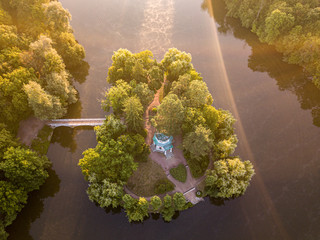 Aerial view of the island with a bridge on the lake. A beautiful marriage ceremony location, in the shape of heart