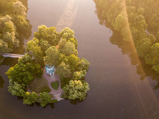 Aerial view of the island with a bridge on the lake. A beautiful marriage ceremony location, in the shape of heart