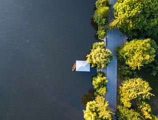 aerial veiw of empty road in green forest with the blue lake. drone shot