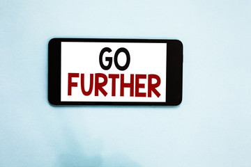 Text sign showing Go Further. Conceptual photo To move to a greater distance or overcome your limitations Cell phone white screen over light blue background text messages apps