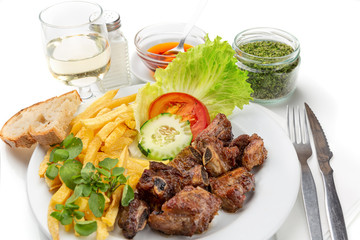 Dish for lunch of fried pork ribs, potatoes and salad. Portuguese dish.