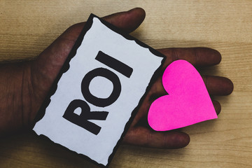 Handwriting text Roi. Concept meaning Return on investment performance measure gains business...