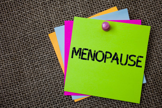 Handwriting text writing Menopause. Concept meaning Cessation of menstruation Older women hormonal changes period Sticky cards board pinned muliple colours remember idea jute background