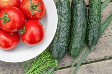 tomatoes and cucumbers on wooden background