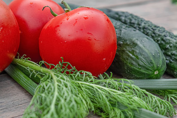tomatoes and cucumbers on wooden background